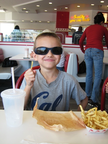 A boy sitting at a table eating food