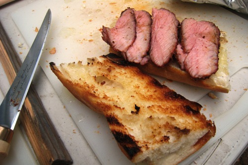 open halves of tri-tip sandwich