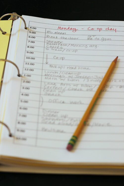 paper in binder with handwritten school schedule with pencil.