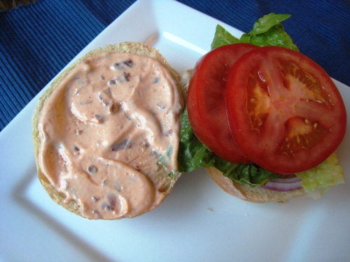 A plate of Hamburger with chipotle mayo on bun