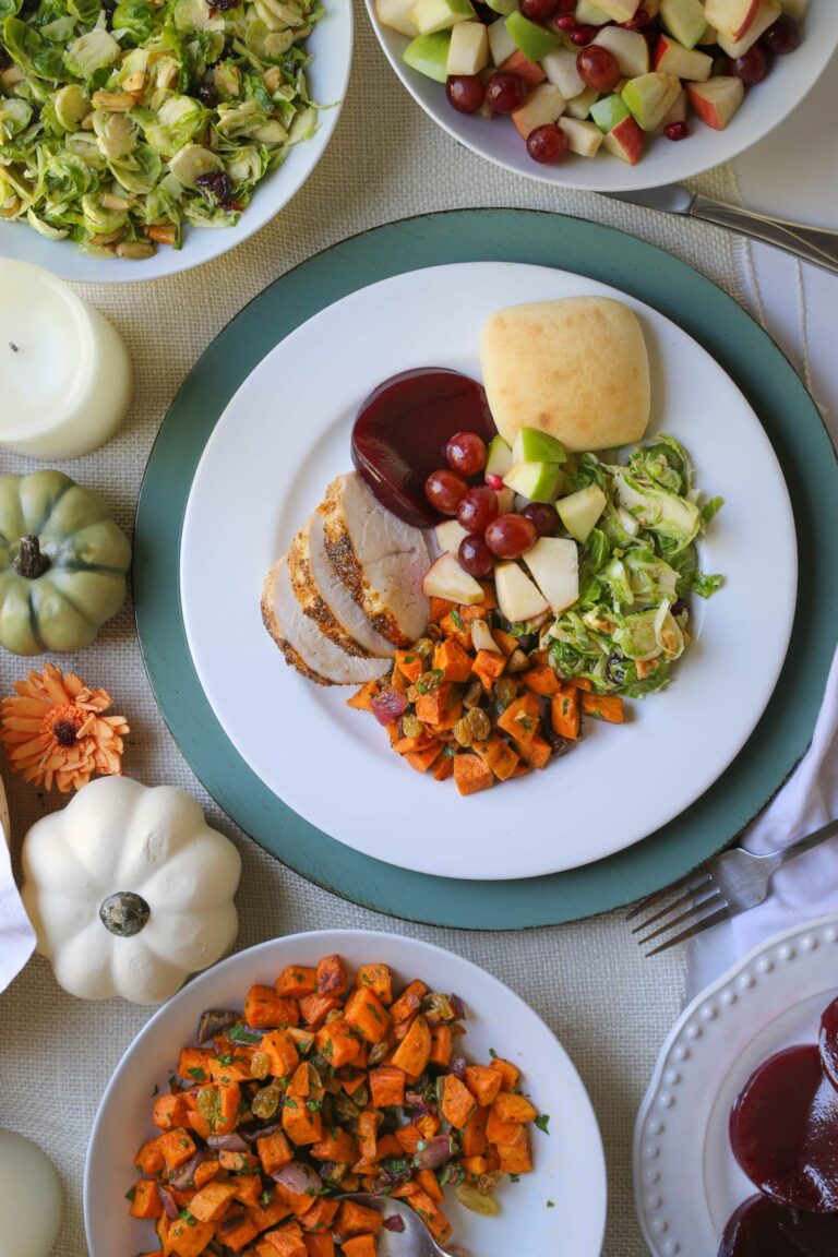 thanksgiving dinner plate surrounded by bowls of side dishes.