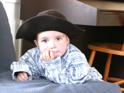 A young boy wearing a cowboy hat 