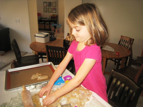 girl cutting out cookies