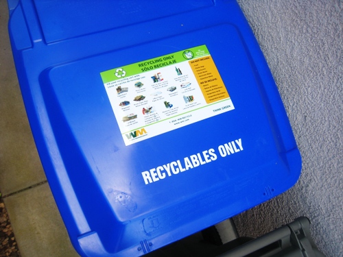 A close up of a recyclable bin.