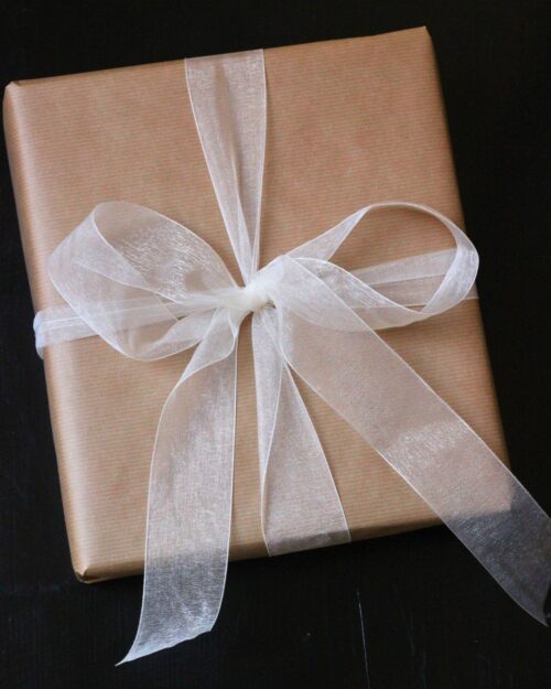brown paper package tied with a white tulle bow.