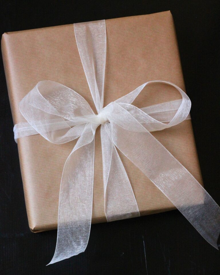brown paper package tied with a white tulle bow.