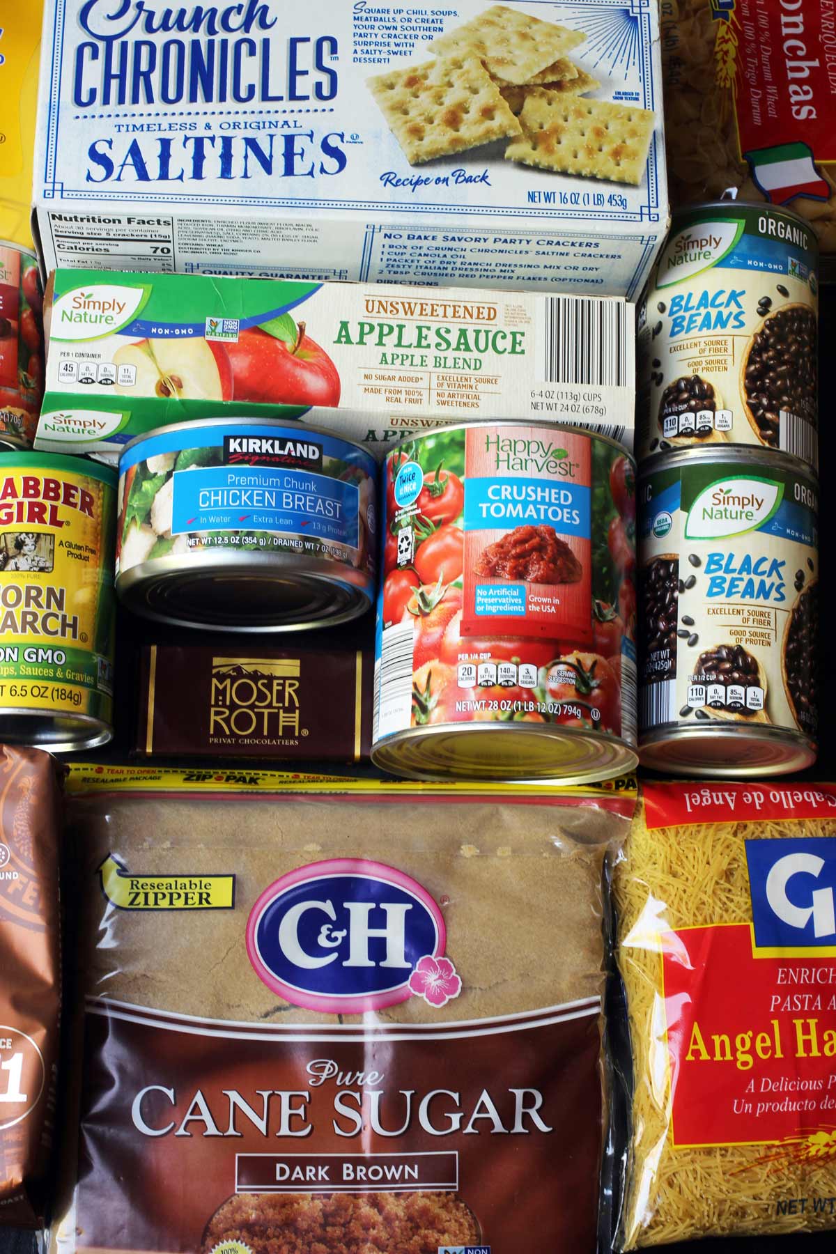 flatlay of pantry ingredients laid out on black table.