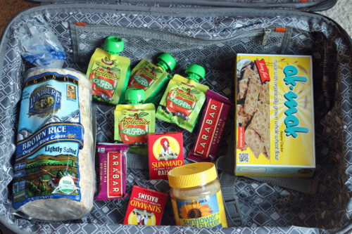suitcase filled with road trip snacks.