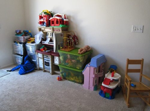kids toys staged in boxes and bins along the wall.