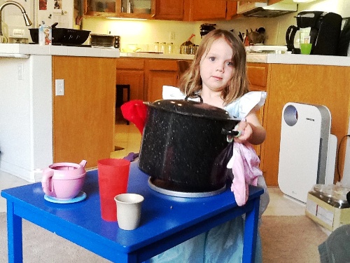 little girl canning in her kitchen