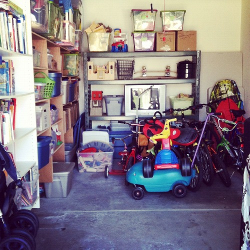 A close up of a small garage filled with toys.