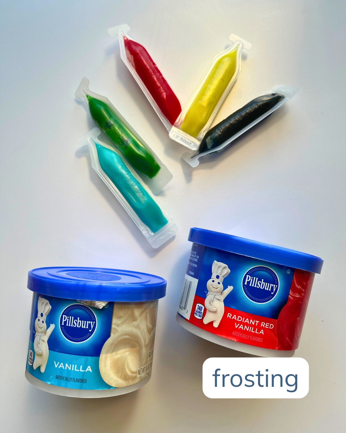 array of frosting options, including small tubs of commercial frosting and tubes of writing icing.