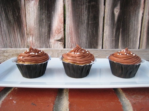 cupcakes on a tray on brick wall