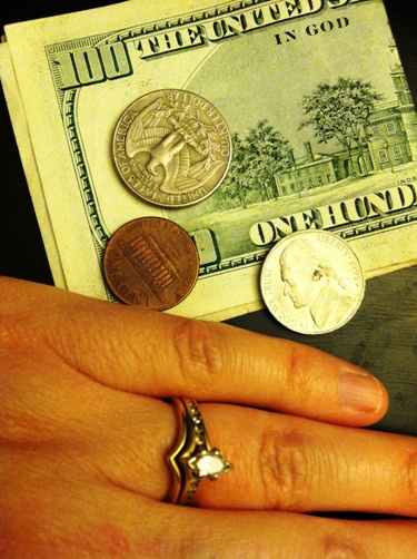 Coins atop a 100 dollar bill.