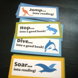 printed valentine bookmarks on a black table.