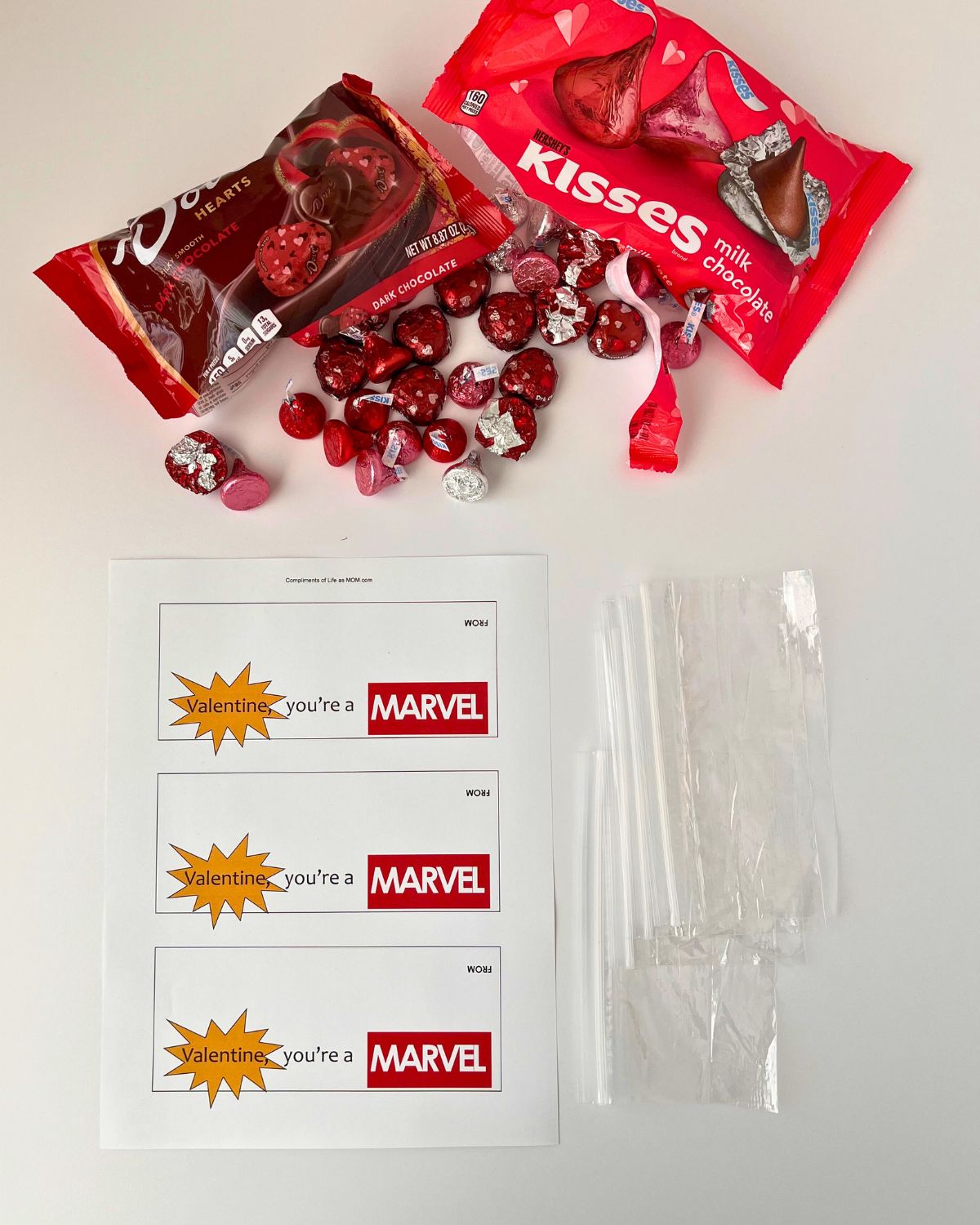 supplies needed for marvel valentines laid out on white table.