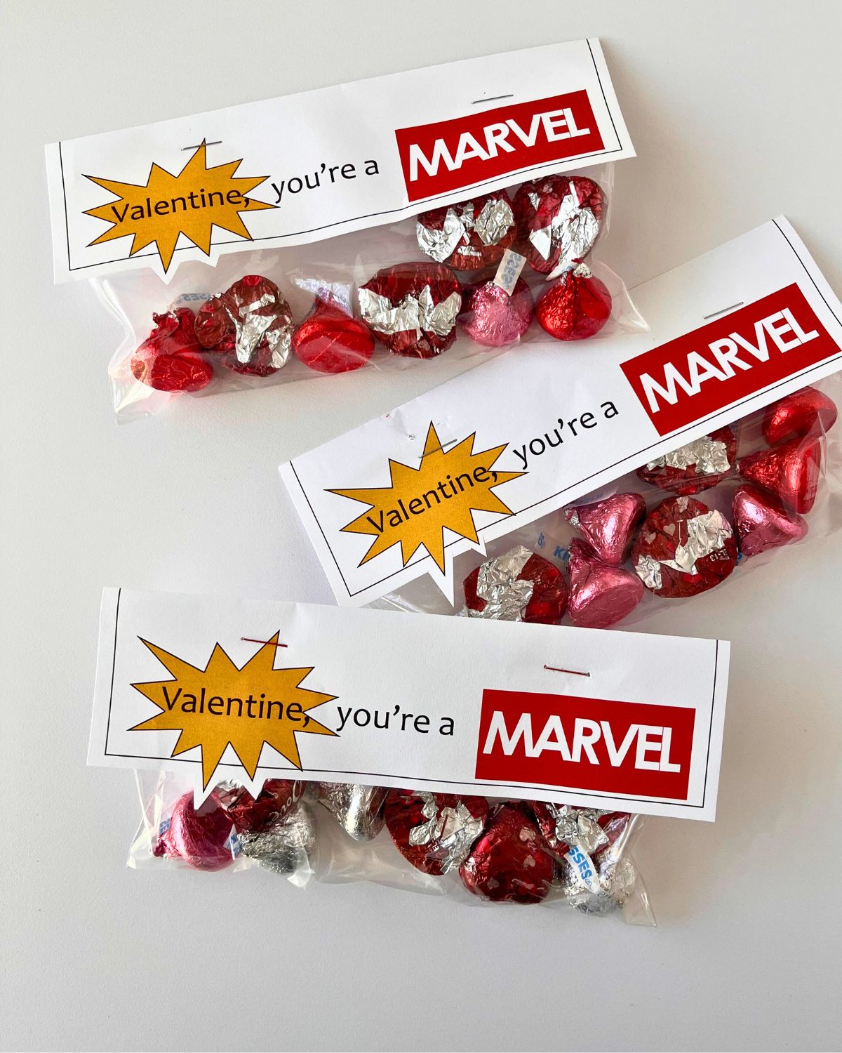 three marvel valentine treat bags on a white table.