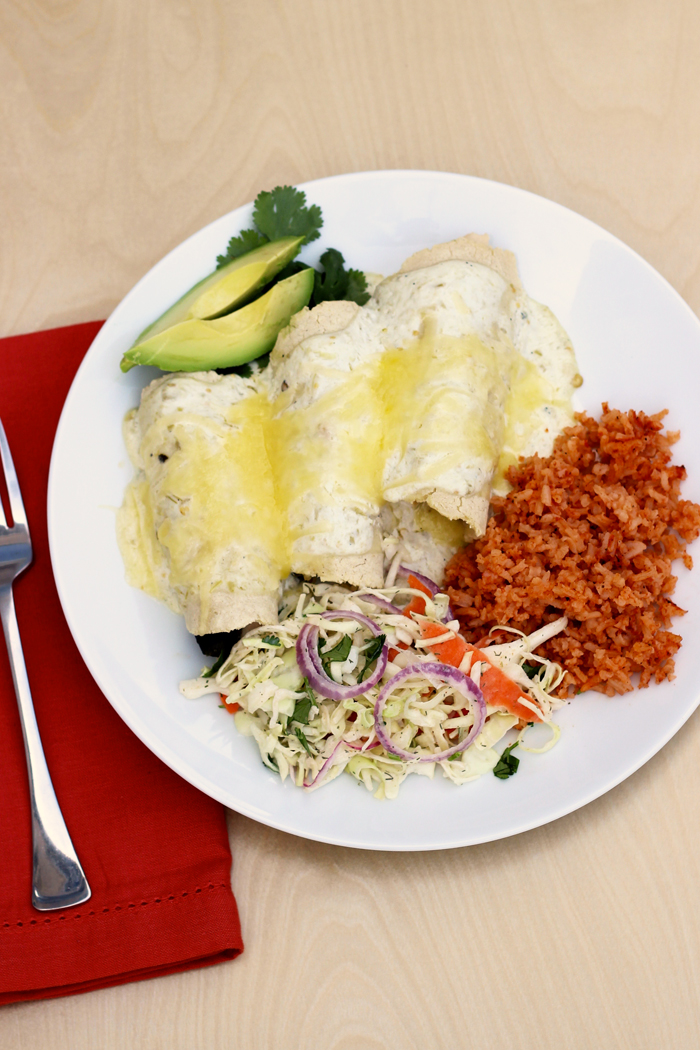 A plate of food on a table, with Poblano Enchiladas