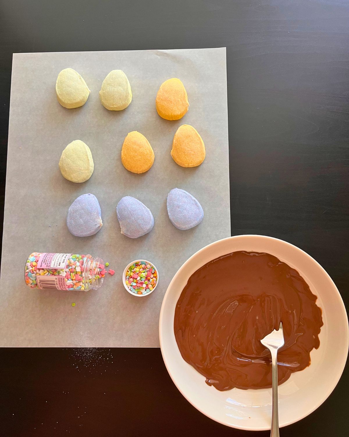 ingredients laid out on parchment, chocolate melted in dish.