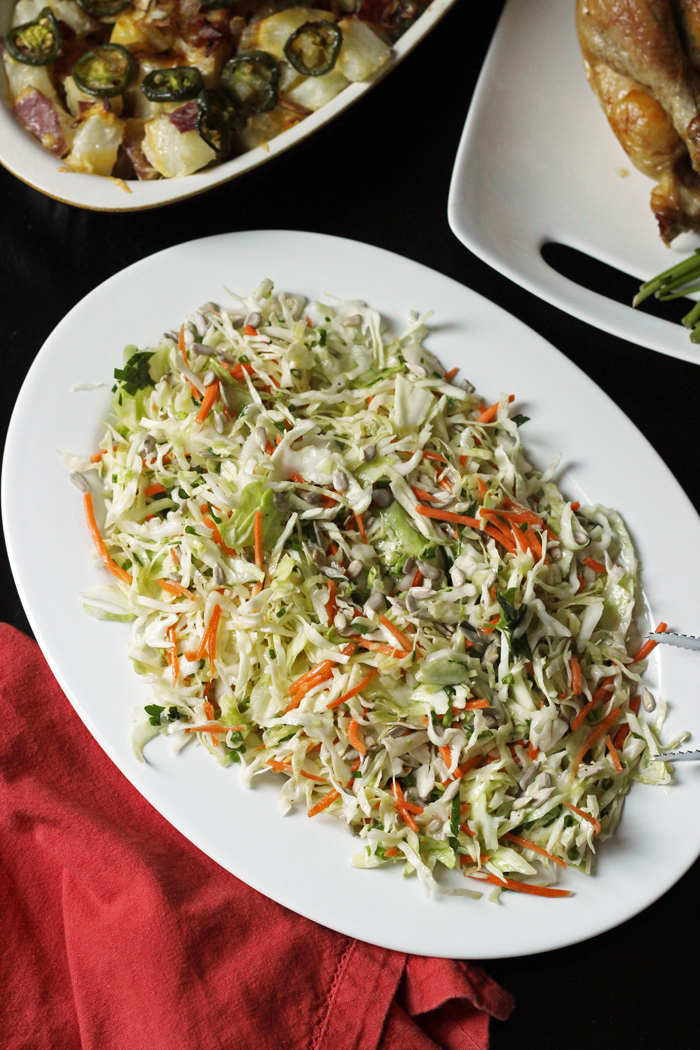 serving platter of coleslaw with potatoes and chicken