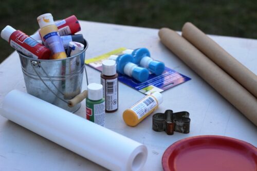 Paint and paper supplies to decorate wrapping paper.