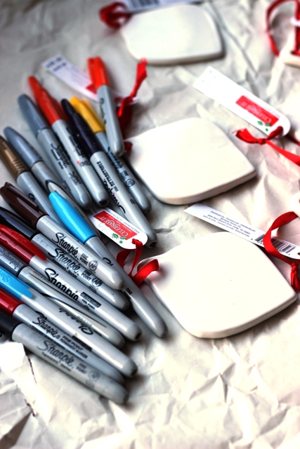 Sharpie pens and ceramic ornaments on a table.