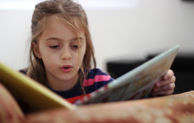 girl learning to read
