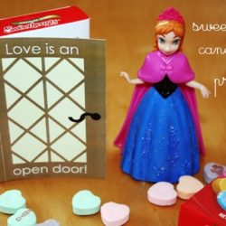 frozen valentine candy box next to anna figurine and conversation hearts.