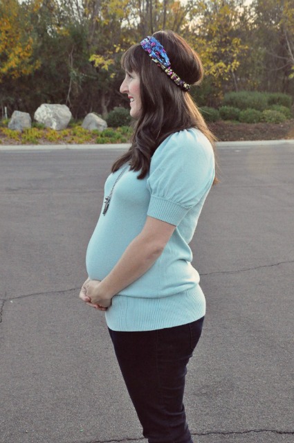 side shot of a pregnant mom with headband.