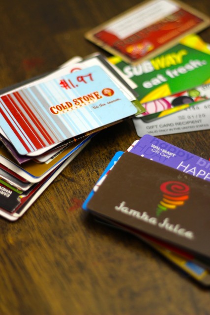 Stacks of gift cards on a table.