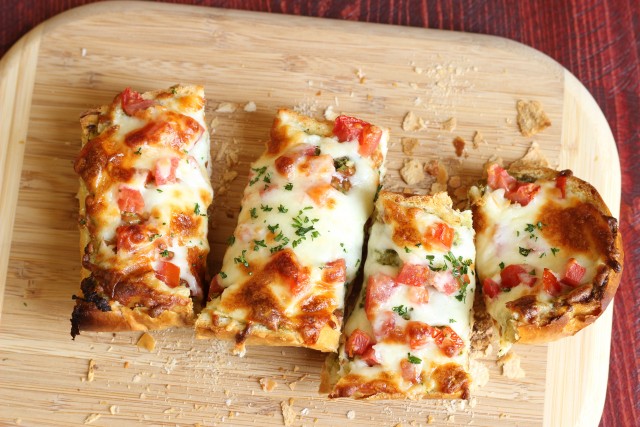 Pesto and Tomato French Bread Pizza - Make delicious homemade pizza in minutes! It's easy and fun and makes for a great appetizer, too.