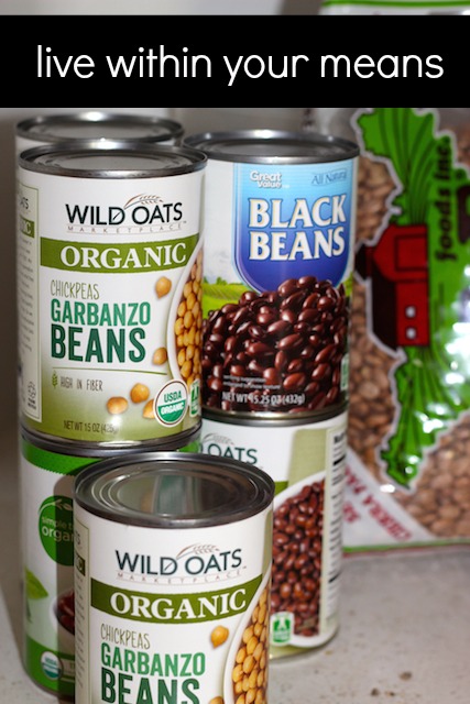 Cans of beans next to a bag of beans.