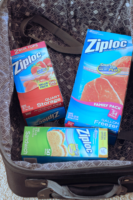 Boxes of Ziploc bags in a suitcase.