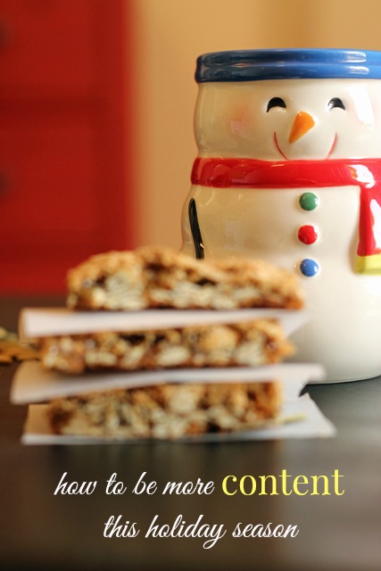 A close up of cookies and a snowman mug on a table.