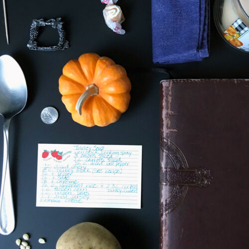 mini pumpkin and recipe card on table with other scavenger hunt items collected.