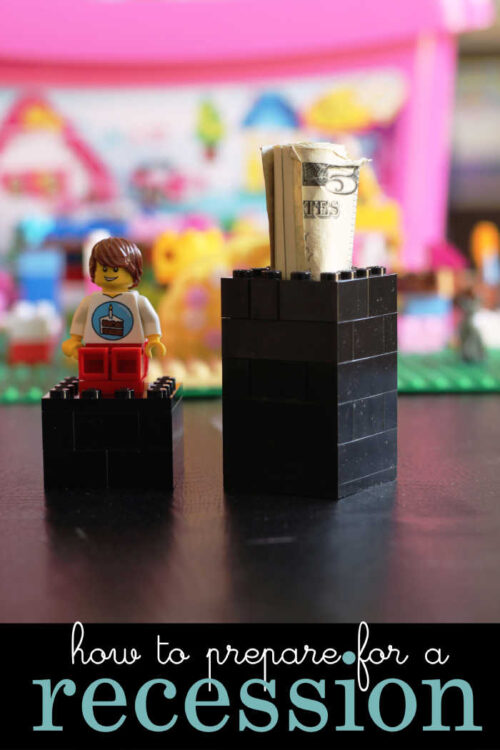 lego money holder with lid removed, rolled bills in the base in front of legos.