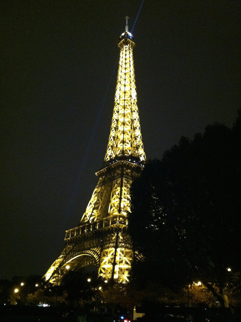 The Eiffel tower lit at night.