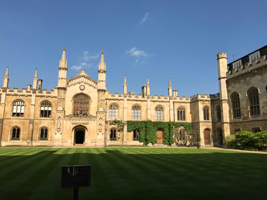 A large brick building with a clock tower in Cambridge.