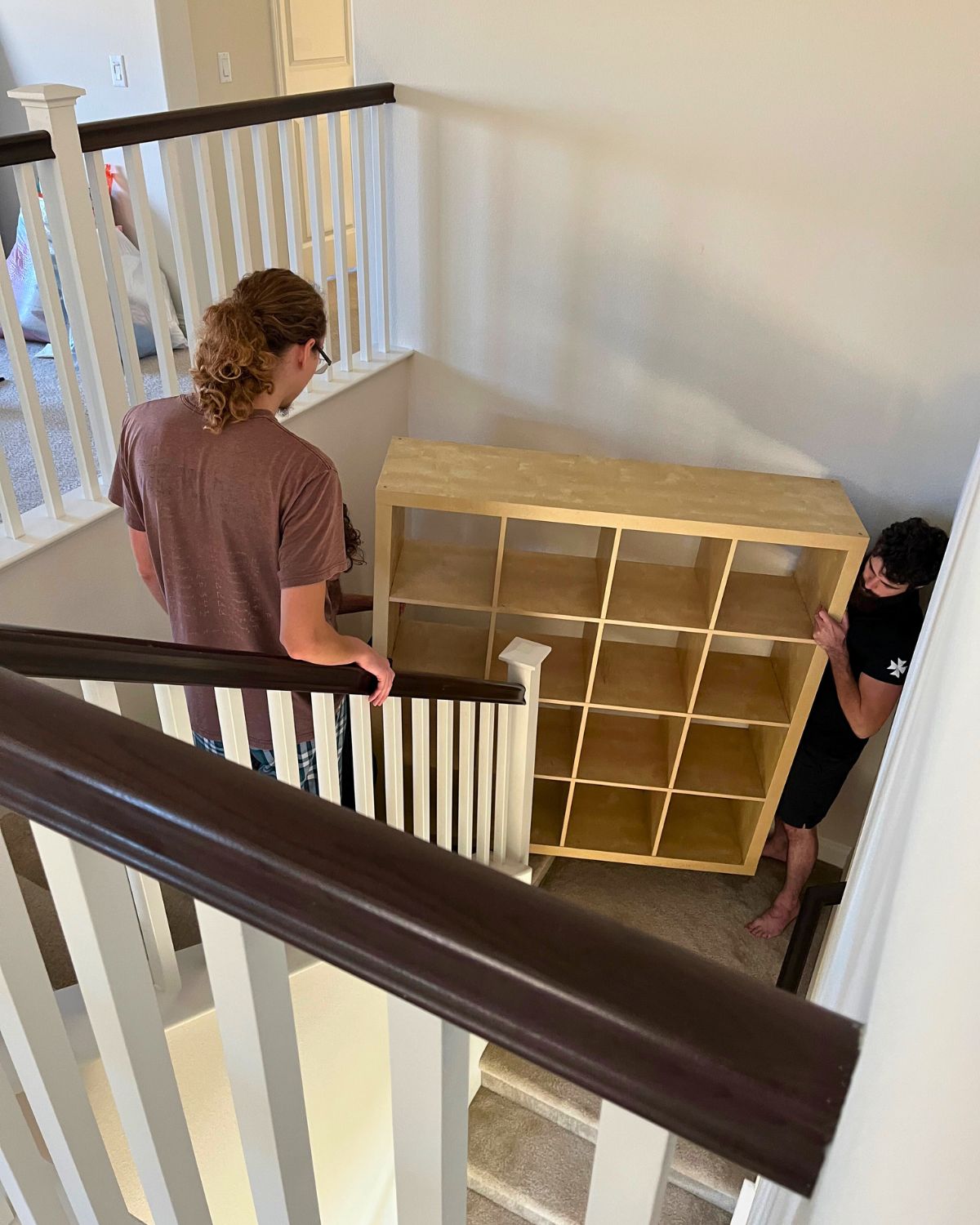 guys moving furniture up the stairs.