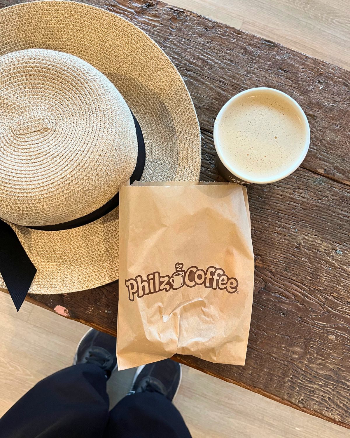 sunhat, pastry bag, and coffee cup from philz coffee.
