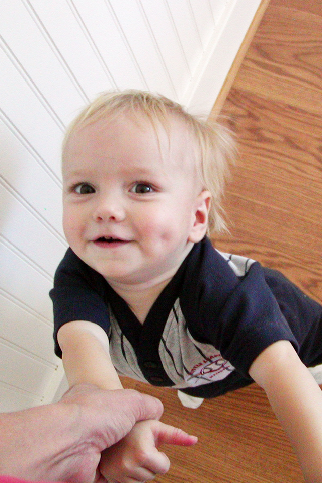 toddler holding mom's hands