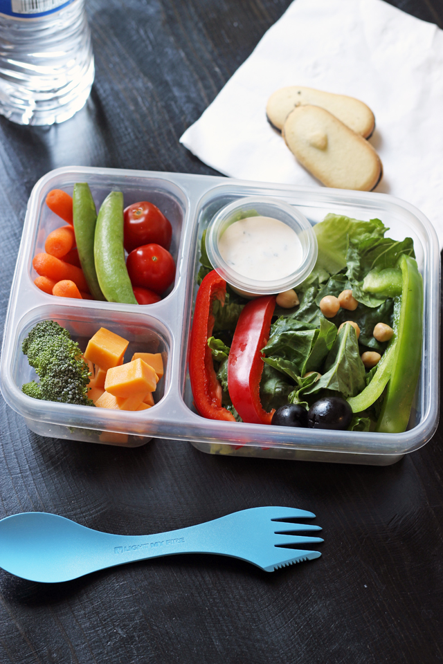 divided lunch box with veggies cheese fruit and dip