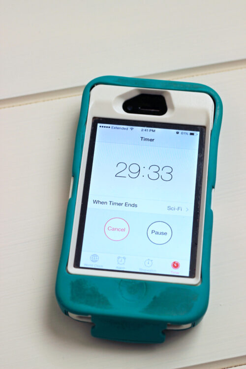 iPhone in teal case with a countdown clock.