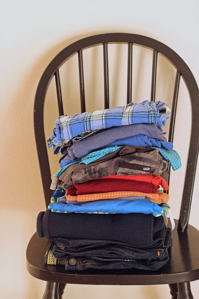 A stack of laundry sitting on top of a chair.