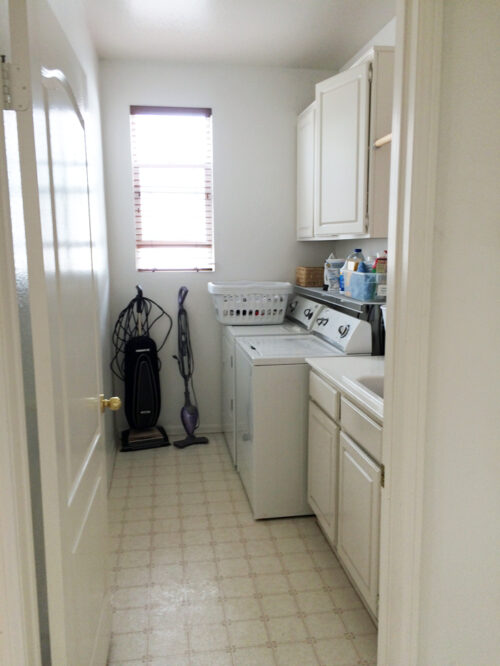 View of laundry room with vacuum, steam mop, washer, dryer, and sink.