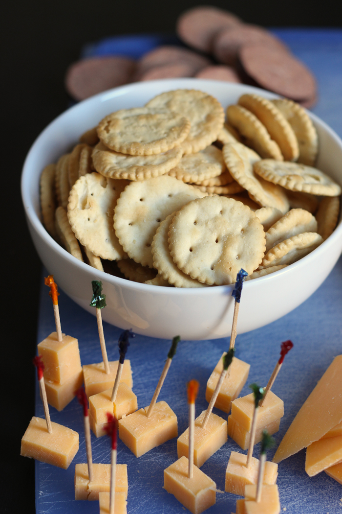 cheese cubes with toothpicks and bowl of crackers