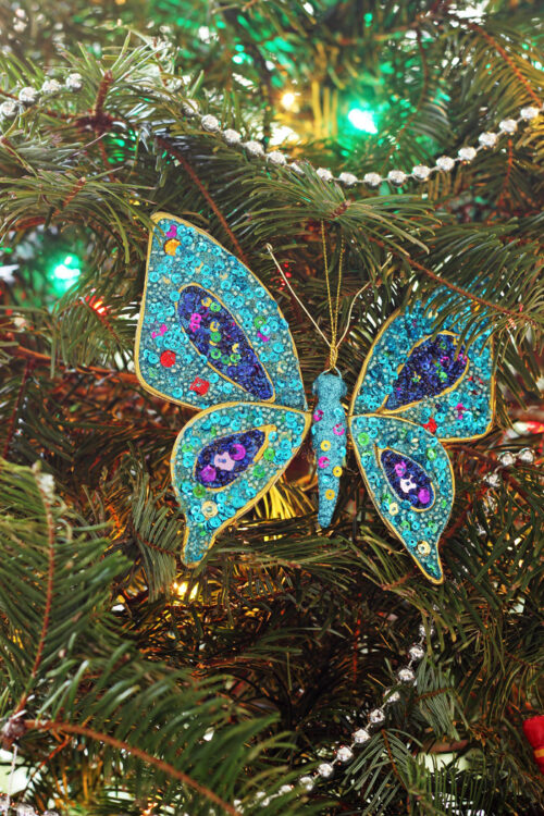 Sparkly butterfly ornament on the Christmas tree.