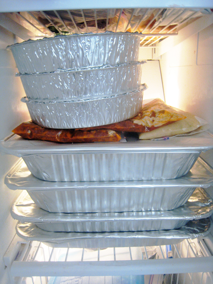 stack of freezer meals in freezer