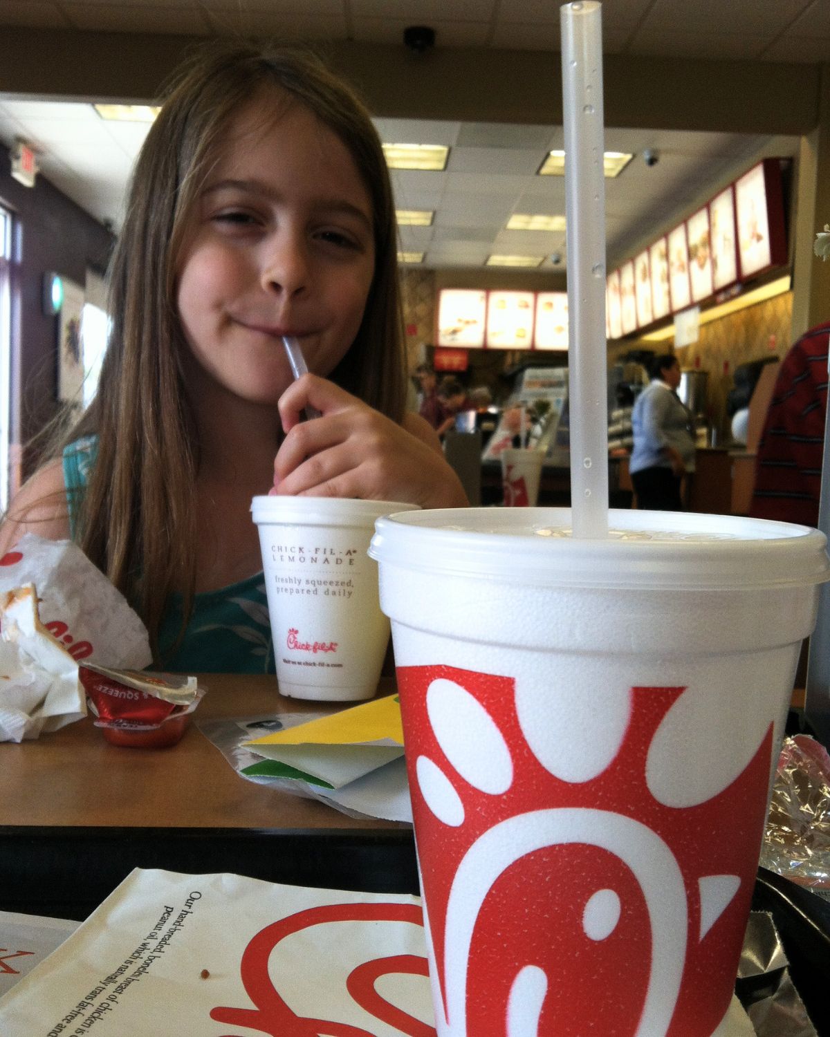girl sipping on drink at chick-fil-a.