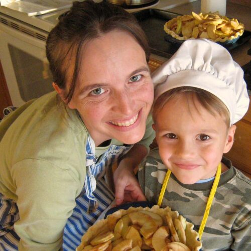 close up of mom and boy with apple pie.